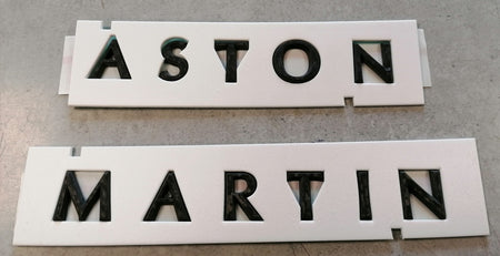 Image of REAR ASTON MARTIN SCRIPT BADGE - CARBON