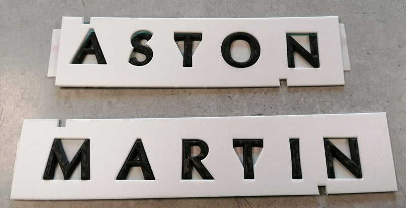 Image of REAR ASTON MARTIN SCRIPT BADGE - CARBON