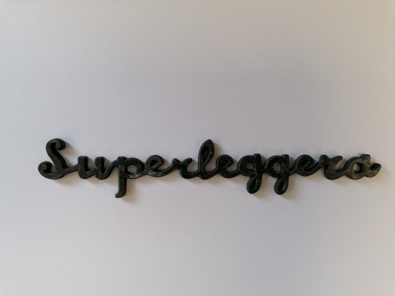 Image of CARBON FIBRE SUPERLEGGERA SCRIPT NAME BADGE