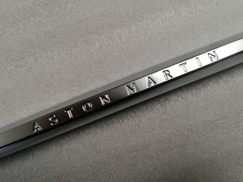 Image of LEFT FRONT WING FENDER CHROME STRAKE WITH THE ASTON MARTIN INSCRIPTION