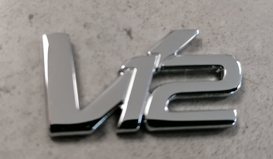 V12 BADGE - CHROME